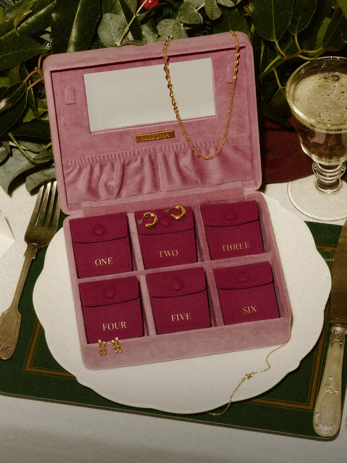 pink advent calendar jewellery box with gold hoop earrings