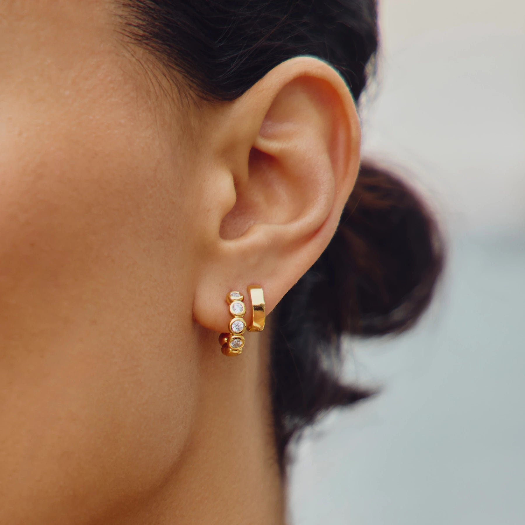 tennis gold hoop earring and gold huggie earrings