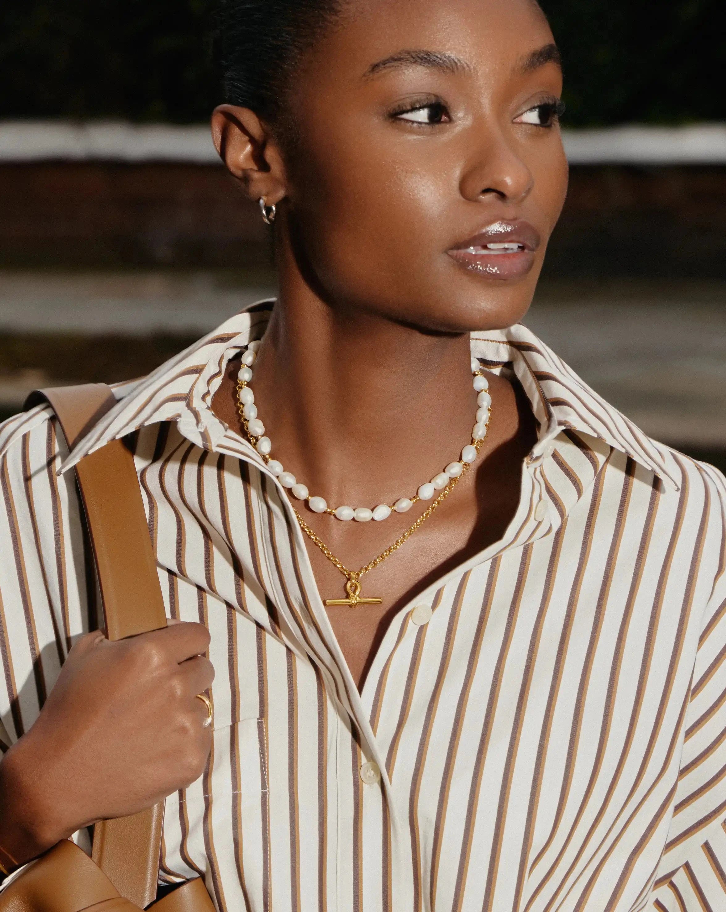 pearl necklace with a chunky gold t-bar necklace